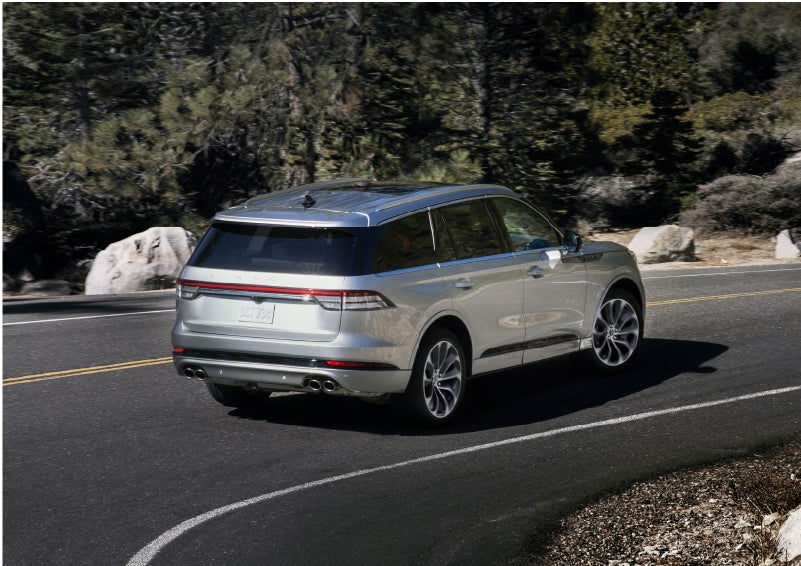 A Lincoln Aviator® is being driven on a winding road | Lincoln Demo 2 in Wooster OH