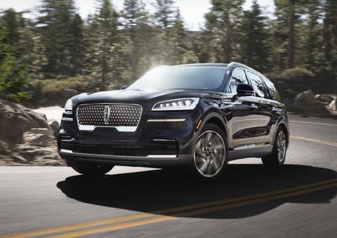 A Lincoln Aviator® SUV is being driven on a winding mountain road | Lincoln Demo 2 in Wooster OH