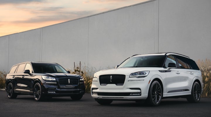 Two Lincoln Aviator® SUVs are shown with the available Jet Appearance Package | Lincoln Demo 2 in Wooster OH