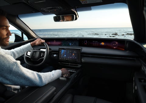 A driver of a parked 2024 Lincoln Nautilus® SUV takes a relaxing moment at a seaside overlook while inside his Nautilus. | Lincoln Demo 2 in Wooster OH