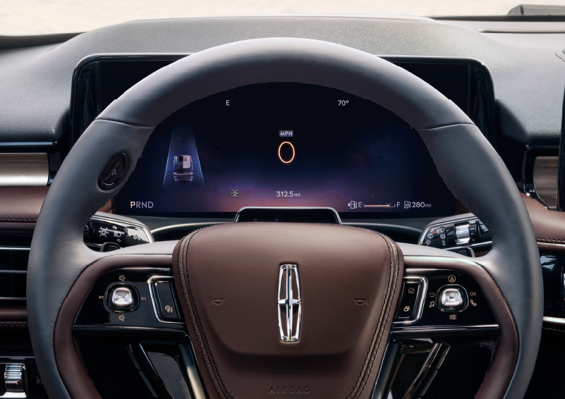 The steering wheel of 2025 Lincoln Aviator® SUV is shown with black and brown accents. | Lincoln Demo 2 in Wooster OH
