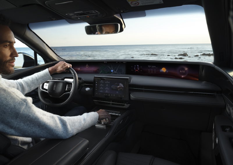 A driver of a parked 2026 Lincoln Nautilus® SUV takes a relaxing moment at a seaside overlook while inside his Nautilus. | Lincoln Demo 2 in Wooster OH