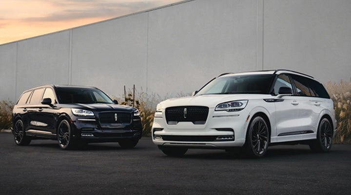 Two Lincoln Aviator® SUVs are shown with the available Jet Appearance Package